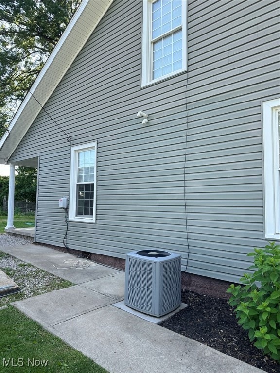 view of side of property featuring a patio and central air condition unit