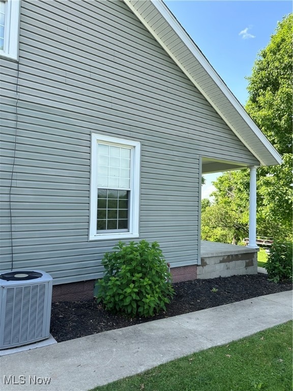 view of side of property with central AC unit