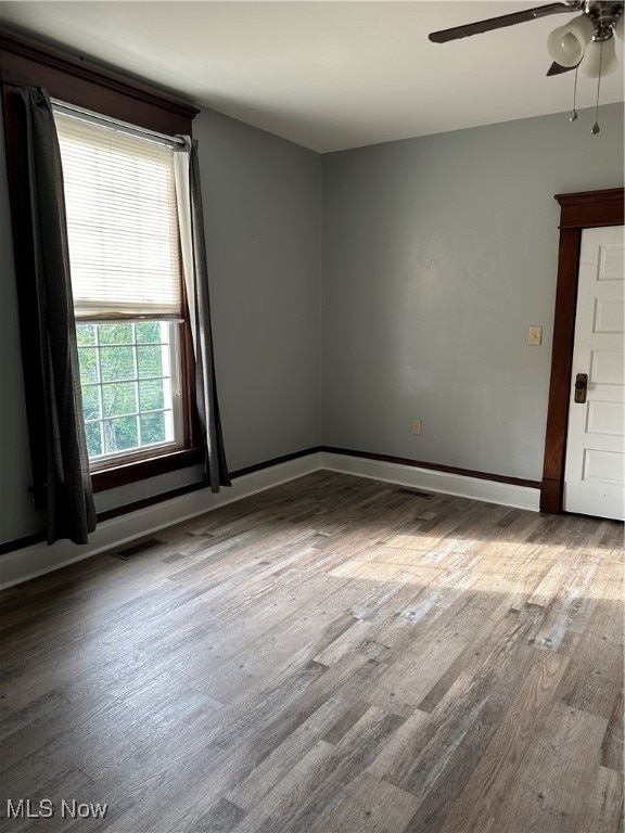 empty room with wood-type flooring and ceiling fan