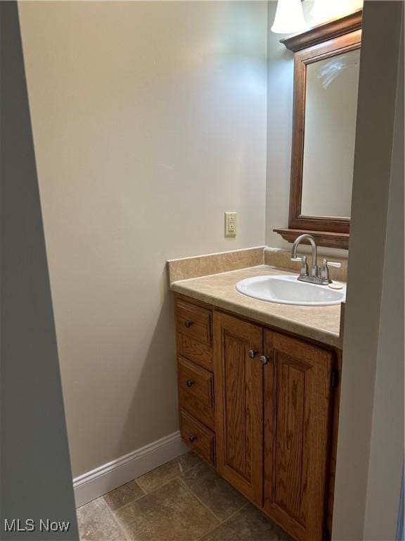 bathroom with baseboards and vanity
