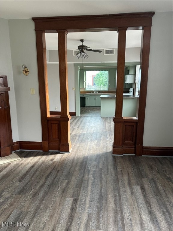 empty room with dark hardwood / wood-style flooring and ceiling fan