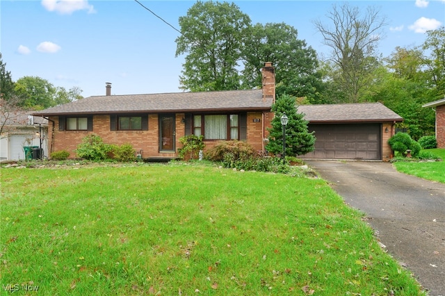 ranch-style home with a garage and a front lawn