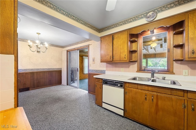 kitchen with dishwasher, hanging light fixtures, sink, and a chandelier