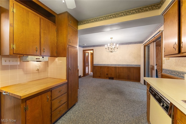 kitchen with dark carpet, dishwasher, a chandelier, hanging light fixtures, and backsplash