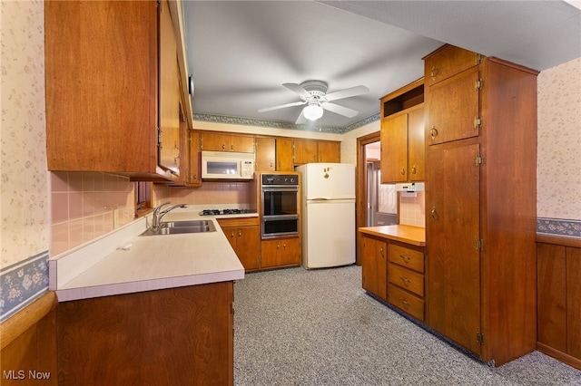 kitchen with white appliances, sink, and ceiling fan