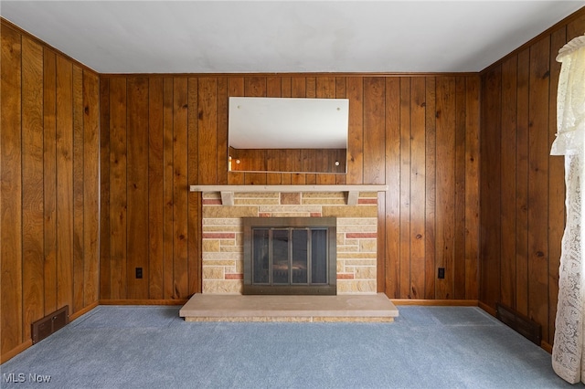 unfurnished living room featuring dark carpet and wooden walls