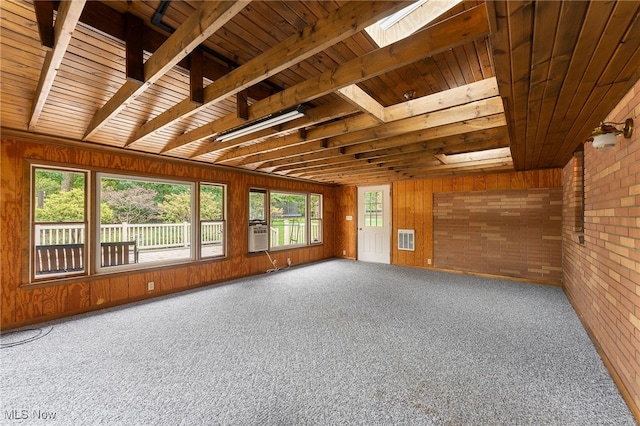 interior space with a healthy amount of sunlight, wood ceiling, cooling unit, and a skylight