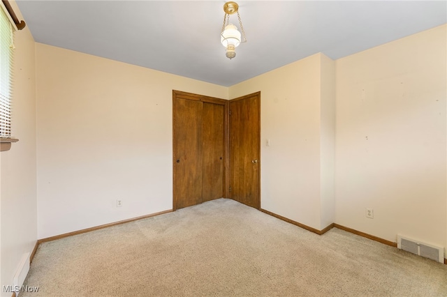 spare room featuring light colored carpet