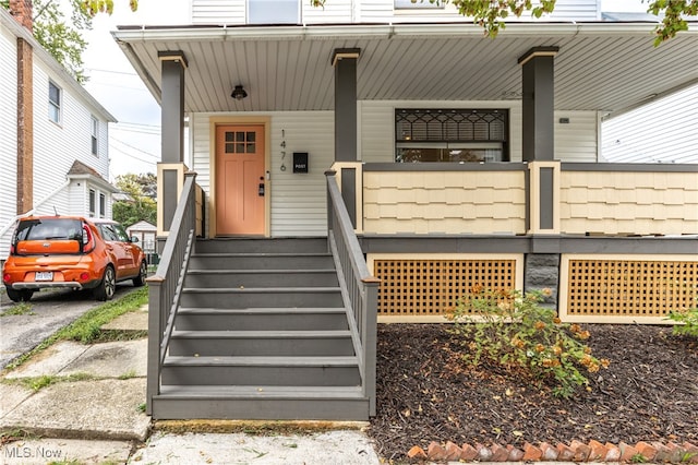 doorway to property featuring a porch