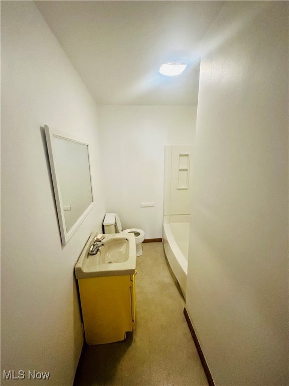 bathroom featuring walk in shower, vanity, and toilet