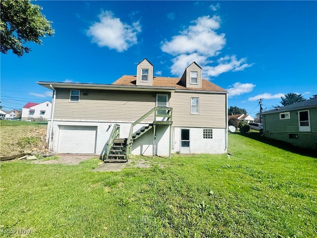 back of house featuring a lawn and a garage