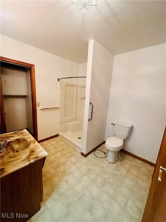 bathroom featuring walk in shower, vanity, and toilet