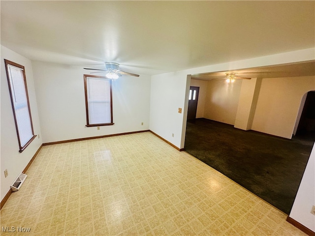 carpeted empty room featuring ceiling fan