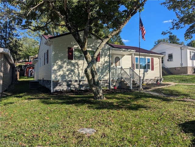 bungalow-style home featuring central AC and a front lawn