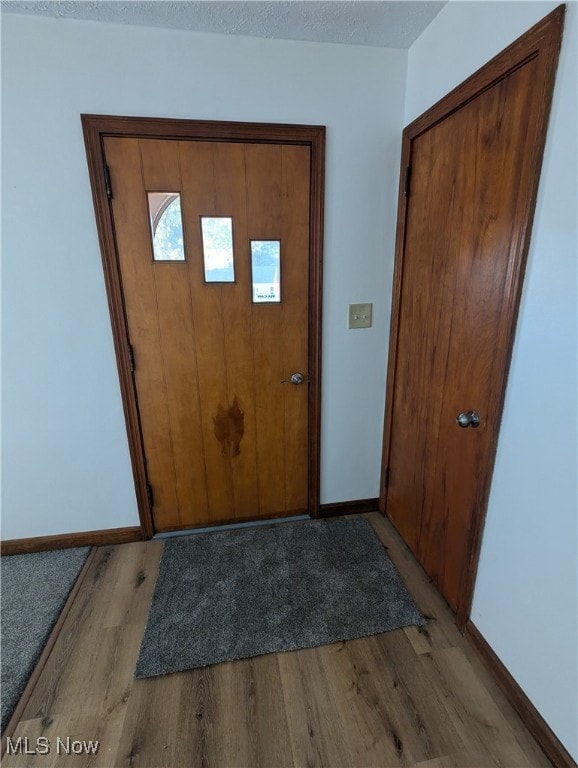 entrance foyer with a textured ceiling and light wood-type flooring