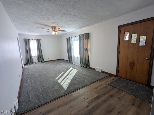 entryway with ceiling fan, plenty of natural light, and hardwood / wood-style floors