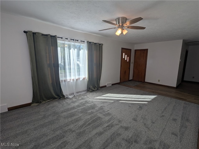 empty room with ceiling fan, a textured ceiling, and hardwood / wood-style flooring