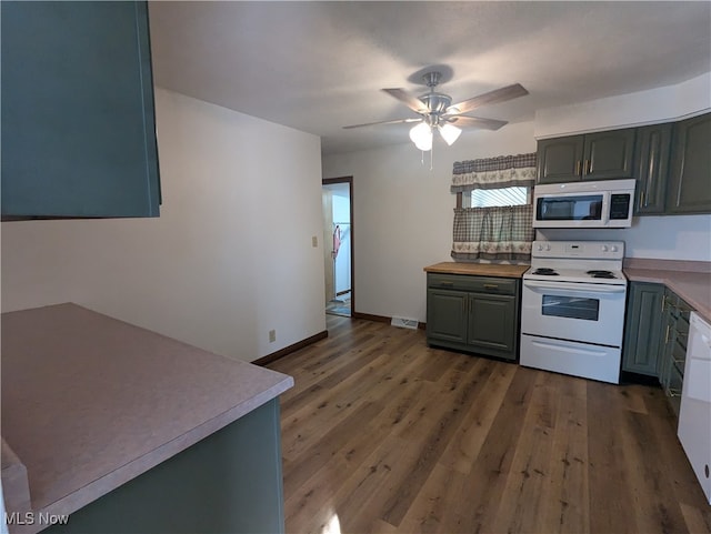 kitchen with ceiling fan, dark hardwood / wood-style floors, and white appliances