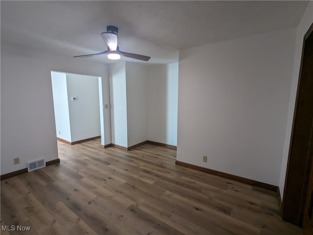 unfurnished room with ceiling fan and hardwood / wood-style floors