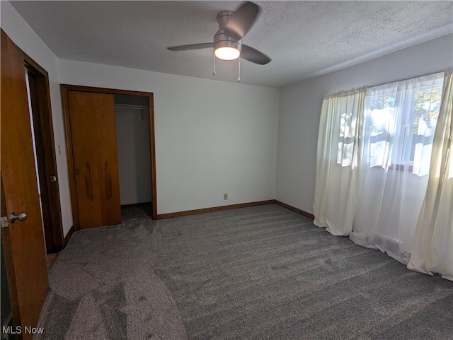 unfurnished bedroom with carpet floors, a textured ceiling, ceiling fan, and a closet