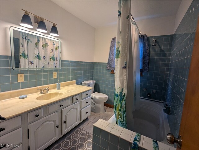 full bathroom with vanity, tile walls, tile patterned flooring, and toilet