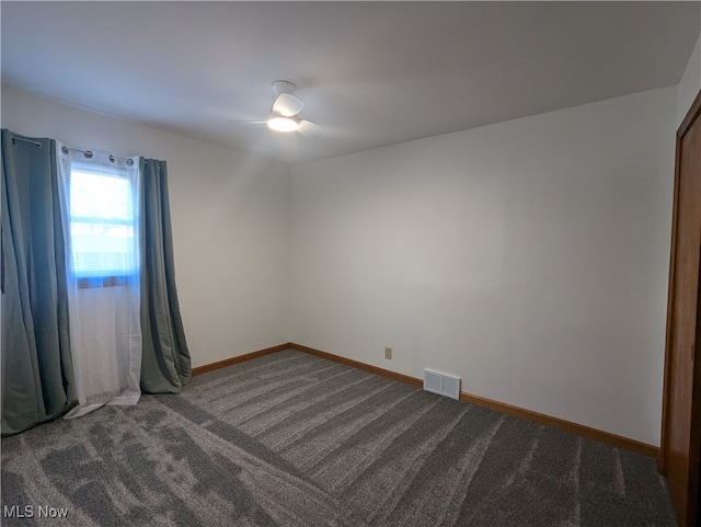 carpeted spare room with ceiling fan