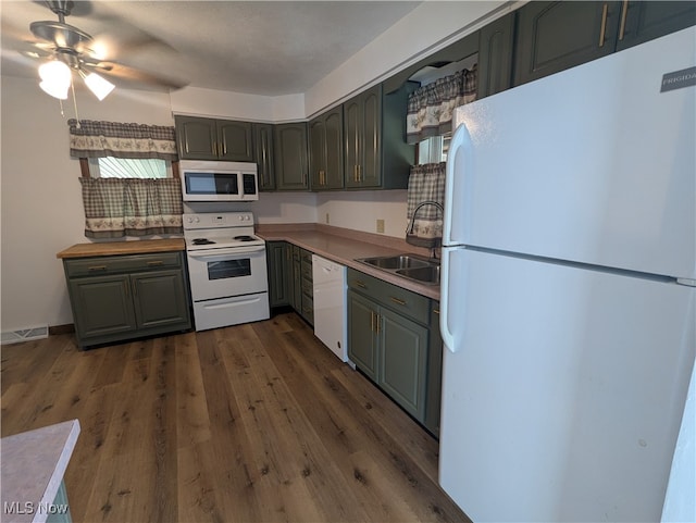 kitchen featuring ceiling fan, dark hardwood / wood-style floors, sink, and white appliances