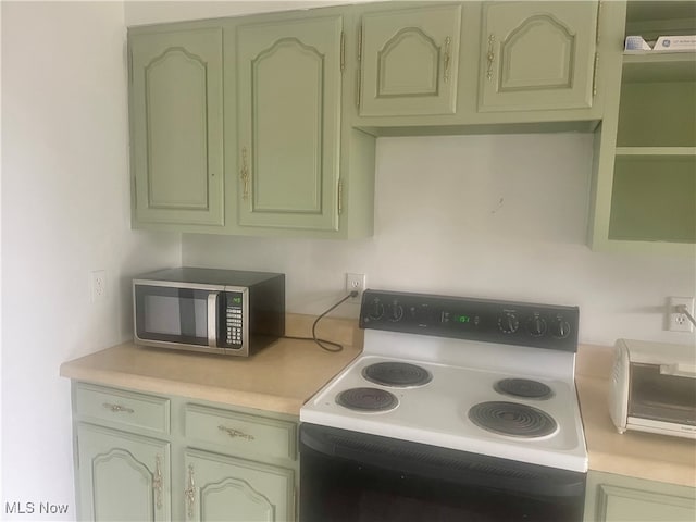 kitchen featuring green cabinets and white range with electric stovetop