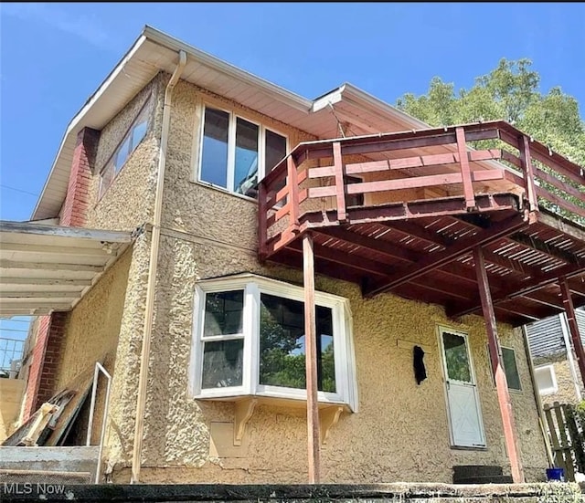 view of side of property with a wooden deck