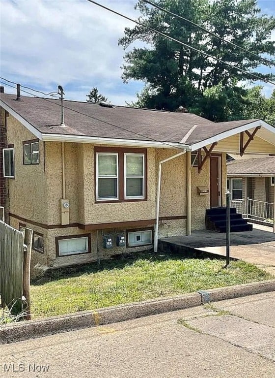 view of side of home with a lawn