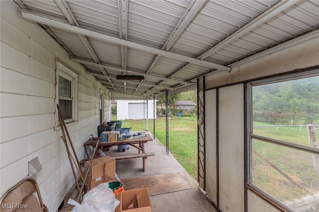 sunroom with a healthy amount of sunlight and lofted ceiling