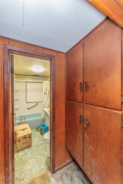 hallway with wood walls