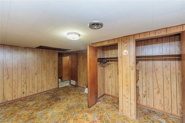 basement featuring wood walls