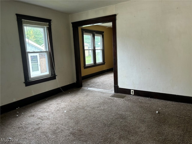 empty room with light carpet and a healthy amount of sunlight