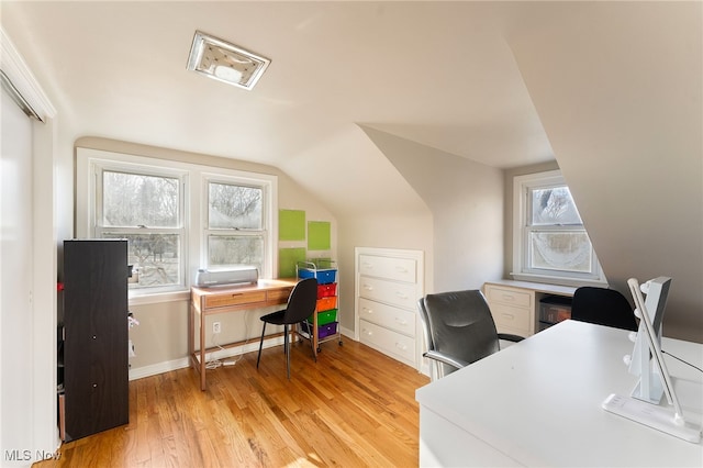 home office with light wood-type flooring and lofted ceiling