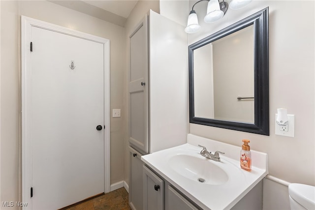 bathroom featuring toilet and vanity