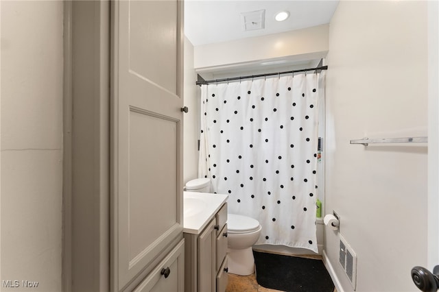 bathroom featuring toilet and vanity