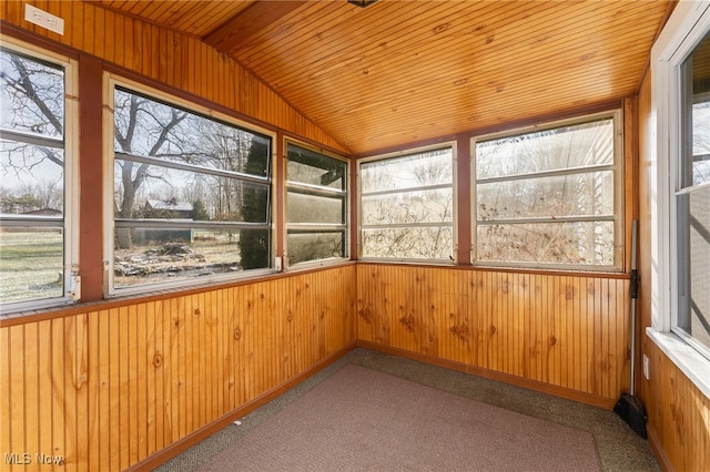 unfurnished sunroom featuring wooden ceiling, plenty of natural light, and lofted ceiling