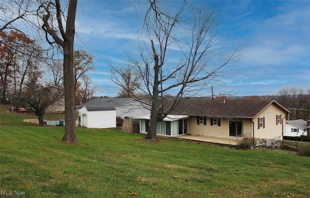 back of house featuring a yard and a patio area