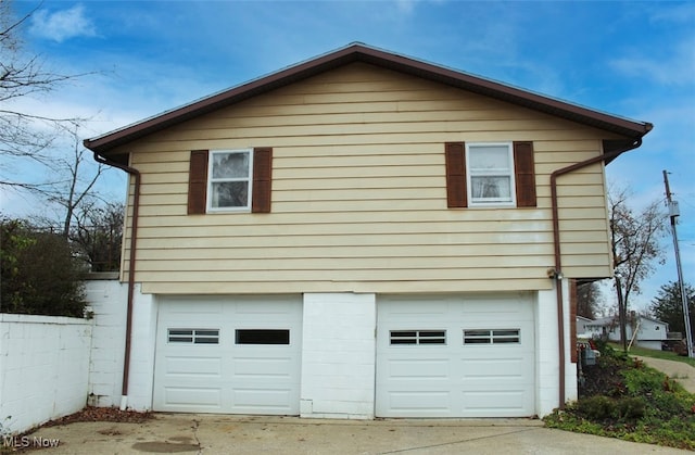 view of side of property with a garage