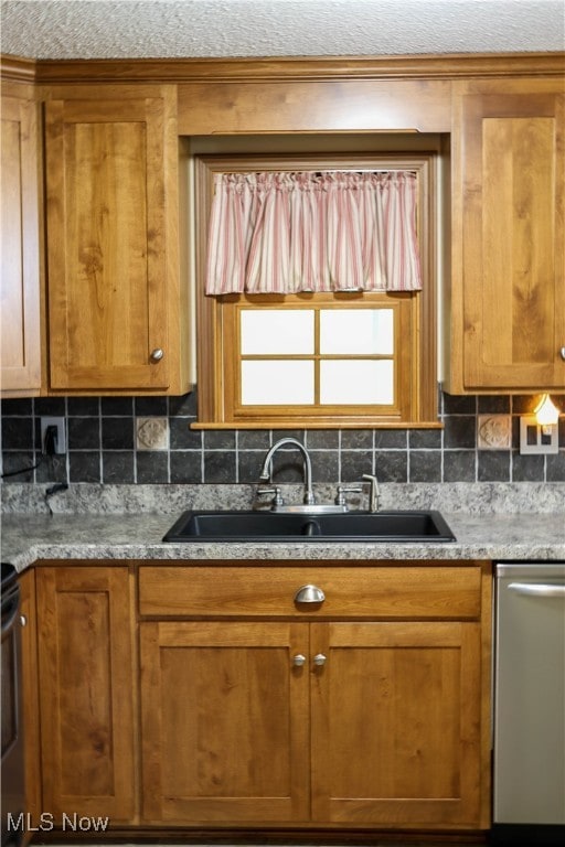 kitchen featuring decorative backsplash, dishwasher, and sink