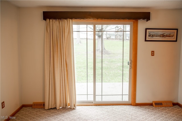 doorway featuring light colored carpet