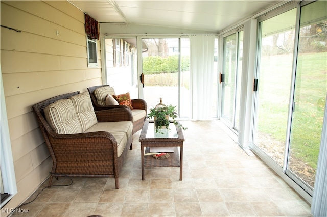 sunroom featuring lofted ceiling