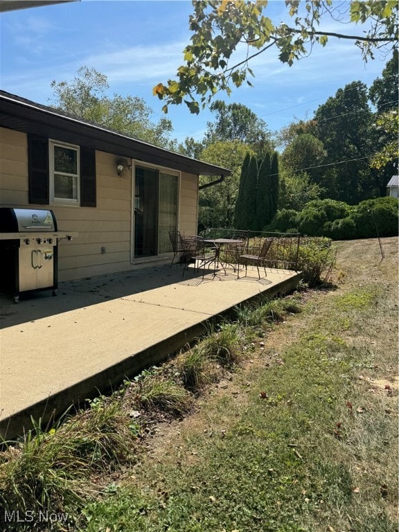 deck featuring a grill and a patio