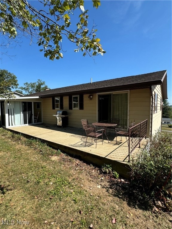 back of house featuring a patio area and a yard