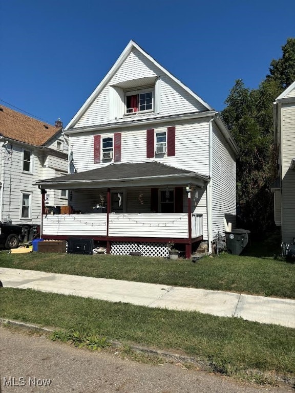 view of front facade with a front lawn and a porch