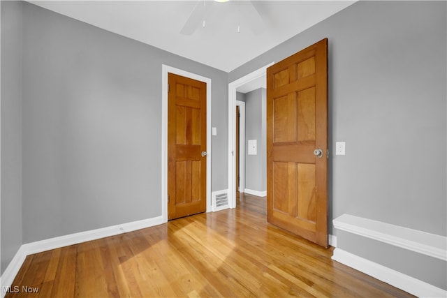 spare room with ceiling fan and light hardwood / wood-style flooring