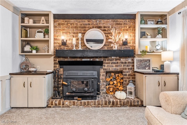 carpeted living room featuring built in shelves and a textured ceiling