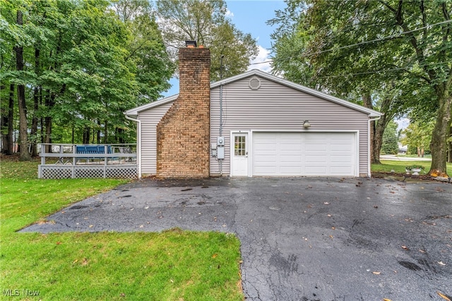 view of property exterior featuring a garage and a lawn