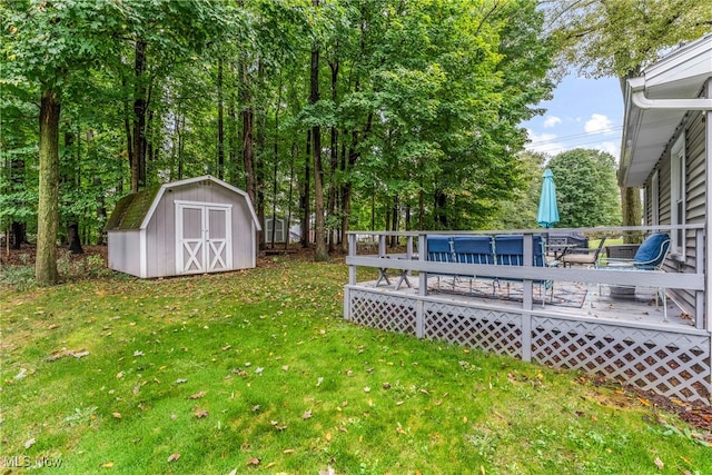 view of yard with a storage shed and a deck